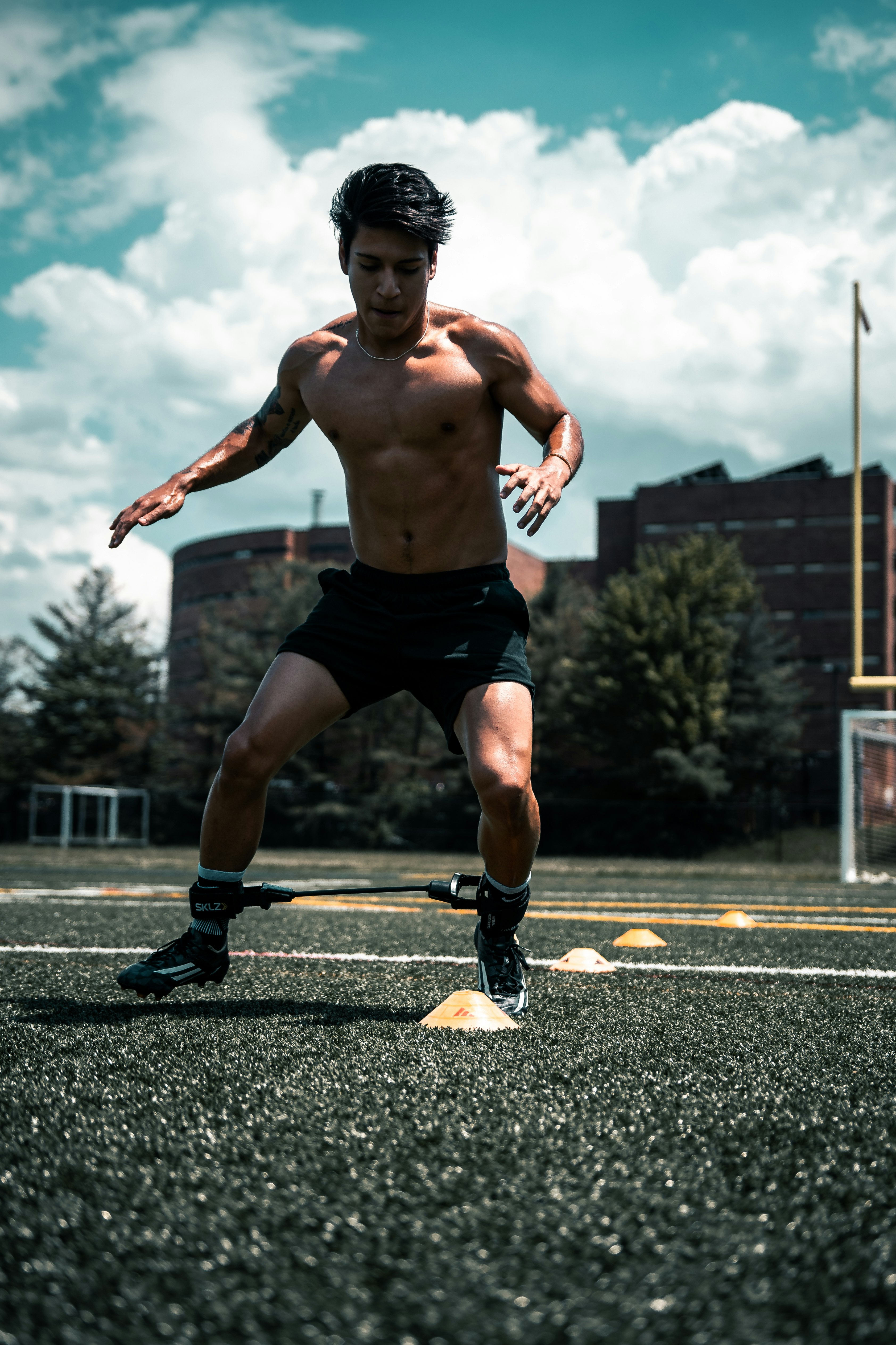 man in black shorts running on gray concrete road during daytime